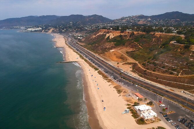 California Beach Towns and Celebrity Homes Private Flexible Tour - Venice Beach Boardwalk: Muscle Beach and the motion show